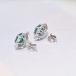 emerald stud earring features a silver setting with gold plating